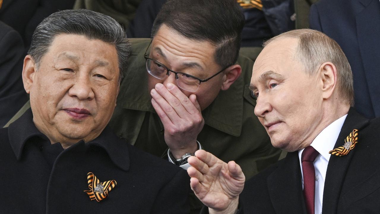 President Vladimir Putin and Chinese President Xi Jinpingtalk as they watch the Victory Day military parade. Picture: Sergei Bobylev/Photo host agency RIA Novosti via AP
