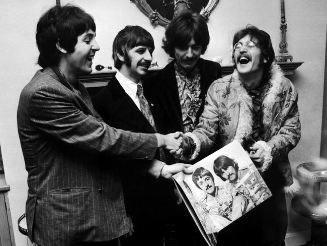 The Beatles (left to right) George Harrison (1943 — 2001), Ringo Starr, John Lennon (1940 — 1980) and Paul McCartney, hold the sleeve of their new LP, 'Sgt. Pepper's Lonely Hearts Club Band', in 1967. Picture: John Downing/Getty