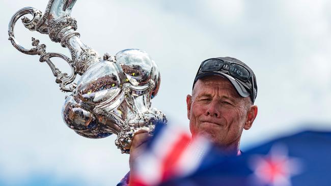 Emirates Team New Zealand CEO Grant Dalton hoists the trophy.