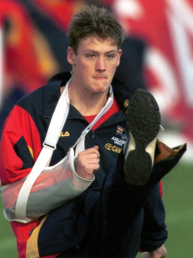 An injured Laurence Angwin with his arm in a sling during an Adelaide Crows training session in 2001.