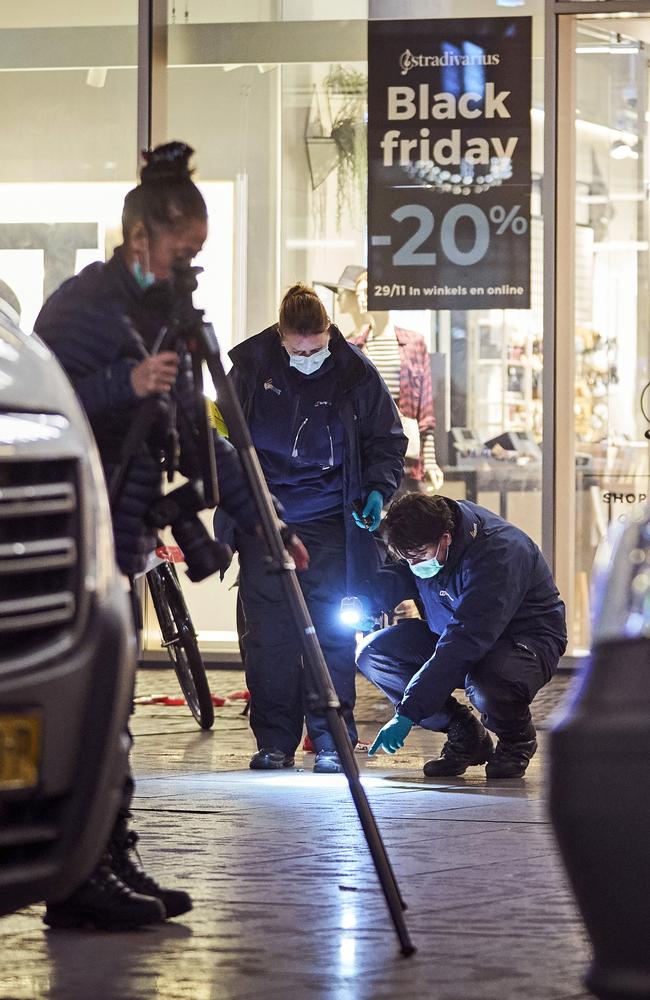 Forensic experts look for clues on the scene of a stabbing incident in the center of The Hague. Picture: AP/Phil Nijhuis