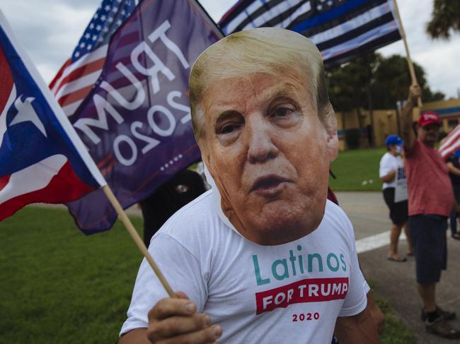 A man wearing a Trump mask stands amongst a group of fellow Trump supporters outside the Osceola Heritage Park where Democratic Presidential Candidate, Joe Biden, was attending a Hispanic Heritage Event. Kissimmee, Florida, USA. Tuesday, September 15th, 2020. (Angus Mordant for NewsCorp Australia)