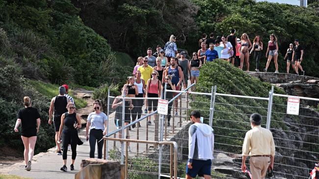 Large crowds exercising on the Bondi to Bronte walk around McKenzies Beach on Sunday. Photographer: Adam Yip