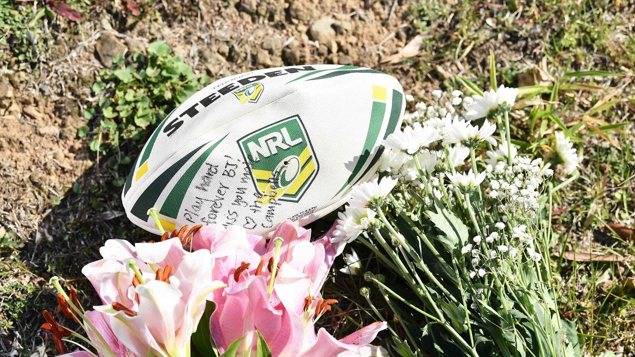 Flowers and a football have been left at the crash site on Image Flat Rd. Picture: Patrick Woods.