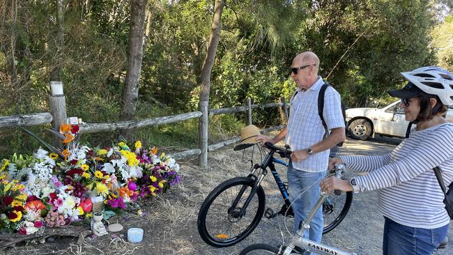 Coffs residents Graham and Jenny at the site of the fatal stabbing of Kye Schaefer – where floral and other tributes have piled high. Picture: Janine Watson/Coffs Coast Advocate