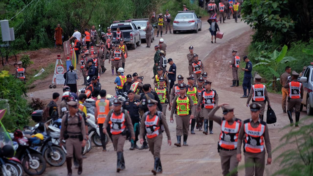 Policeman line up on the main road leading to Tham Luang Nang Non cave where the boys and their coach are trapped. Picture: Linh Pham/Getty Images.