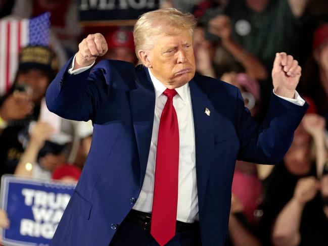 US President Donald Trump gestures at the at the end of an event to mark his 100th Day in office achievement speech at Macomb County Community College Sports Expo Center in Warren, Michigan, on April 29, 2025. (Photo by JEFF KOWALSKY / AFP)