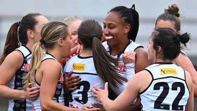 MELBOURNE, AUSTRALIA - OCTOBER 15: Emily Smith of the Magpies is congratulated by team mates after kicking a goal during the round seven AFLW match between Carlton Blues and Collingwood Magpies at Ikon Park, on October 15, 2023, in Melbourne, Australia. (Photo by Quinn Rooney/Getty Images)