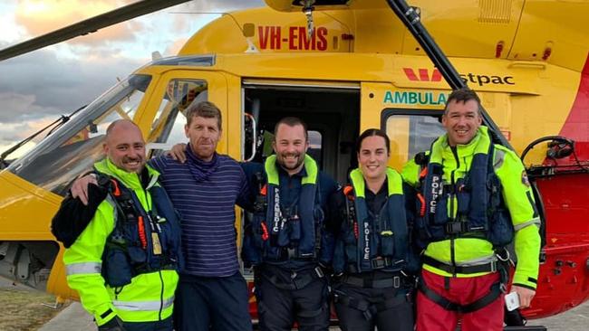 Michael Bowman with his rescuers. Picture: Tasmania Police