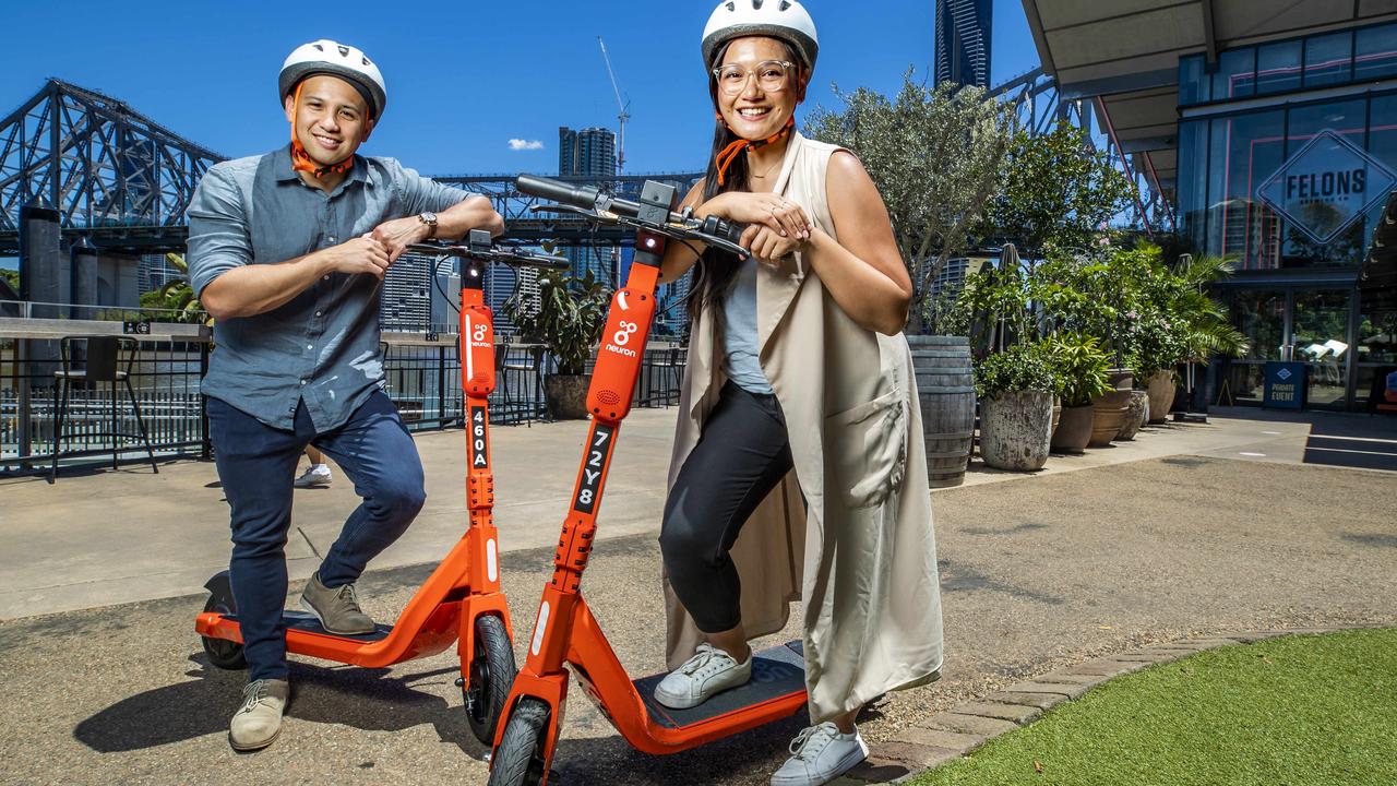 Lorenz Villalba from Bowen Hills and Jairaldine Cruz from Springfield enjoy Howard Smith Wharves by Neuron e-scooter. Picture: Richard Walker