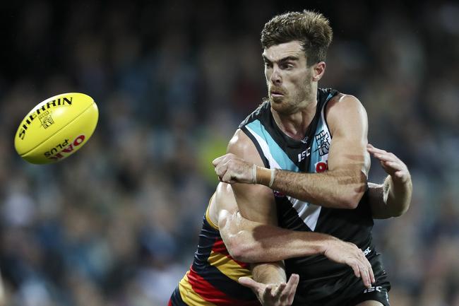 Port Adelaide’s Scott Lycett gets his handball despite the pressure from Adelaide in Showdown 46 at Adelaide Oval. Picture Sarah Reed