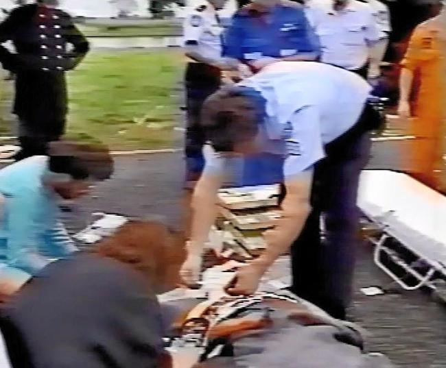 Video footage captures Dr Maureen Hepburn (black cardigan) and Dr Ray Jones (teal jumper) provide medical treatment to an injured passenger at the Cowper crash site. Picture: Jenna Thompson