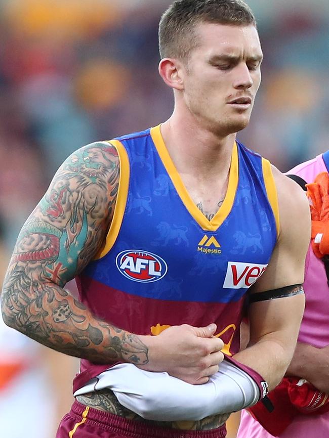 Injured Brisbane captain Dayne Beams leaves the field.