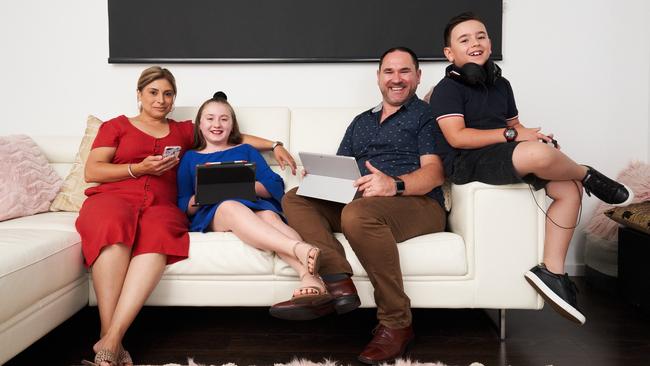 Karyn and Nick Route pose for a picture with their kids Angelique, 9 and Ethan, 8 at home in Pasadena. Picture: Matt Loxton