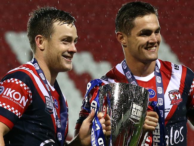 ST HELENS, ENGLAND - FEBRUARY 22: Luke Keary (L) and Kyle Flanagan (R) of Sydney Roosters hold the trophy following victory in the World Club Series Final between St Helens and Sydney Roosters at Totally Wicked Stadium on February 22, 2020 in St Helens, England. (Photo by Lewis Storey/Getty Images)