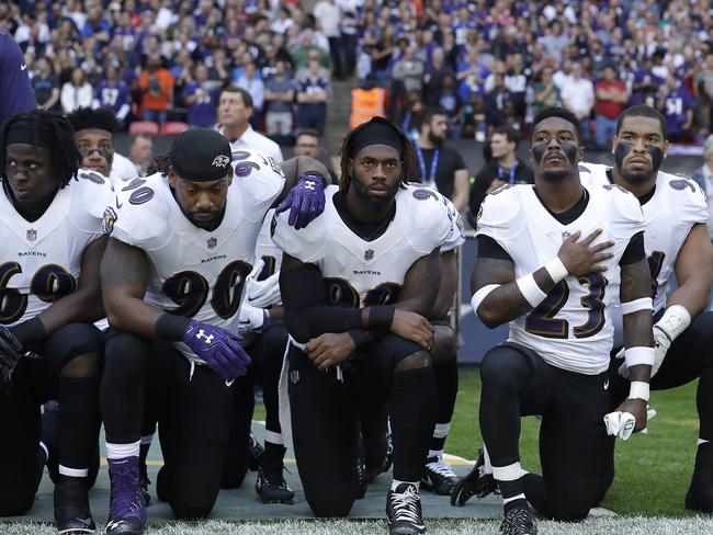 Baltimore Ravens players kneel down during the playing of the U.S. national anthem before an NFL football game against the Jacksonville Jaguars at Wembley Stadium in London, Sunday Sept. 24, 2017. (AP Photo/Matt Dunham)