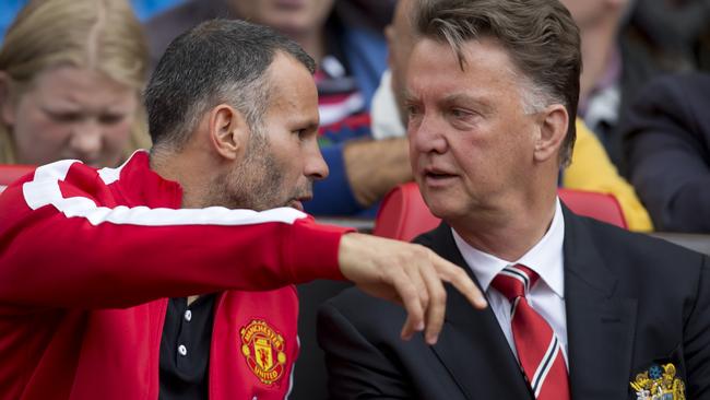 Manchester United's manager Louis van Gaal talks tactics with Ryan Giggs.