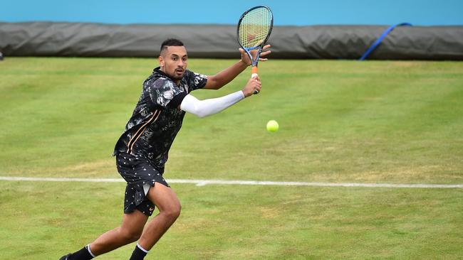 Australia's Nick Kyrgios returns against Spain's Roberto Carballes Baena during their men's singles round of 32 tennis match at the ATP Fever-Tree Championships tournament at Queen's Club in west London on June 20, 2019. (Photo by Glyn KIRK / AFP)