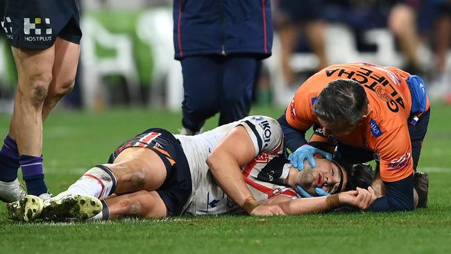 Sydney Roosters lock Victor Radley is attended to by a team trainer after suffering a serious concussion in 2022.