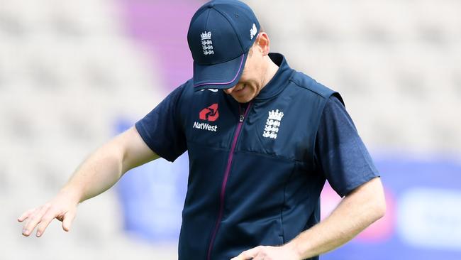 Eoin Morgan recoils in pain after being struck on the finger.