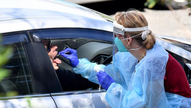 Healthcare workers take COVID-19 tests of Brisbane residents in Herston on Monday. Picture: John Gass