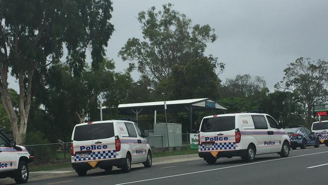 Police vehicles outside Helensvale State School yesterday.