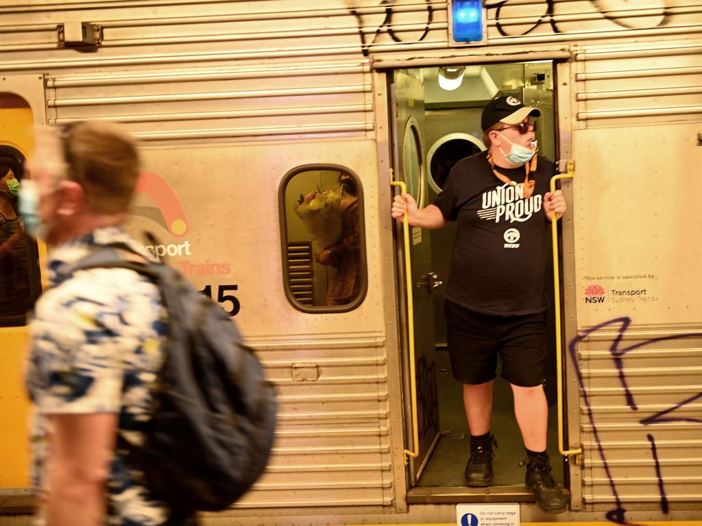 A train workers wears a Union shirt as commuters line the platform at Wynyard station as industrial action began at 6pm as train workers strike. Picture: NCA NewsWire / Jeremy Piper