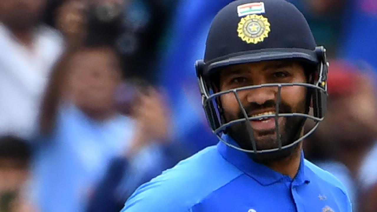 TOPSHOT - India's Rohit Sharma celebrates making his century during the 2019 Cricket World Cup group stage match between Bangladesh and India at Edgbaston in Birmingham, central England, on July 2, 2019. (Photo by Paul ELLIS / AFP) / RESTRICTED TO EDITORIAL USE