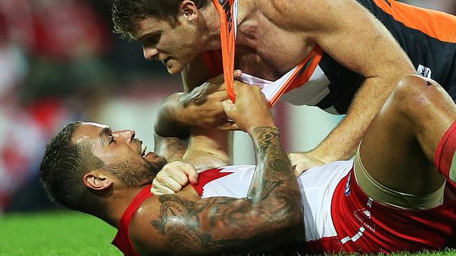 Lance Franklin wrestles with Heath Shaw during one of their derby clashes. Picture: Phil Hillyard