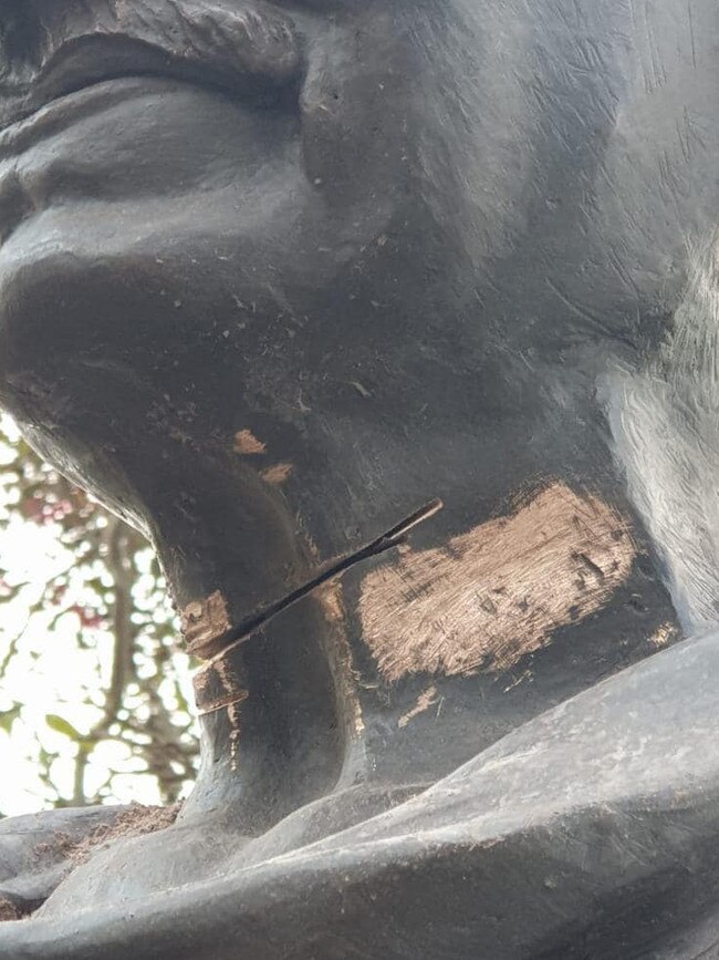 Vandals tried to cut off the head of the statue.