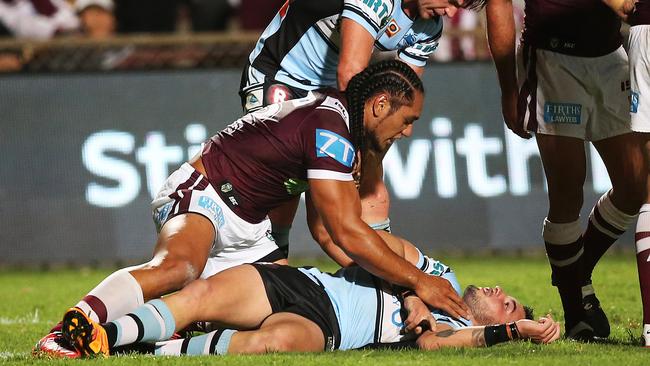 Manly's Martin Taupau looks on at Jack Bird after he knocked him out with late hit.