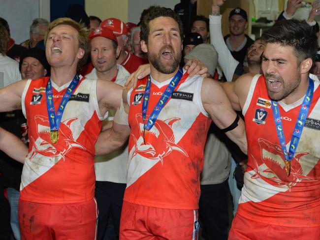 Nepean football league Grand Final: Sorrento v Frankston at Frankston Park. The Sharks went into the grand final as favourites and delivered another flag with a comfortable win over the Bombers. (L-R) Aaron Paxton, Troy Schwarze and Chris Dawes belt out the song. Picture: AAP/ Chris Eastman