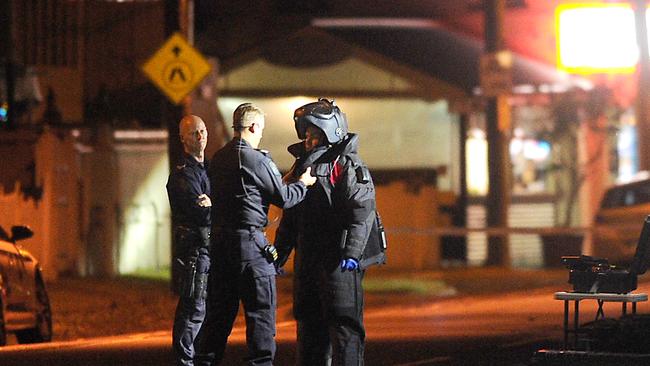 Police officer getting into a bomb suit. Picture: John Gass.