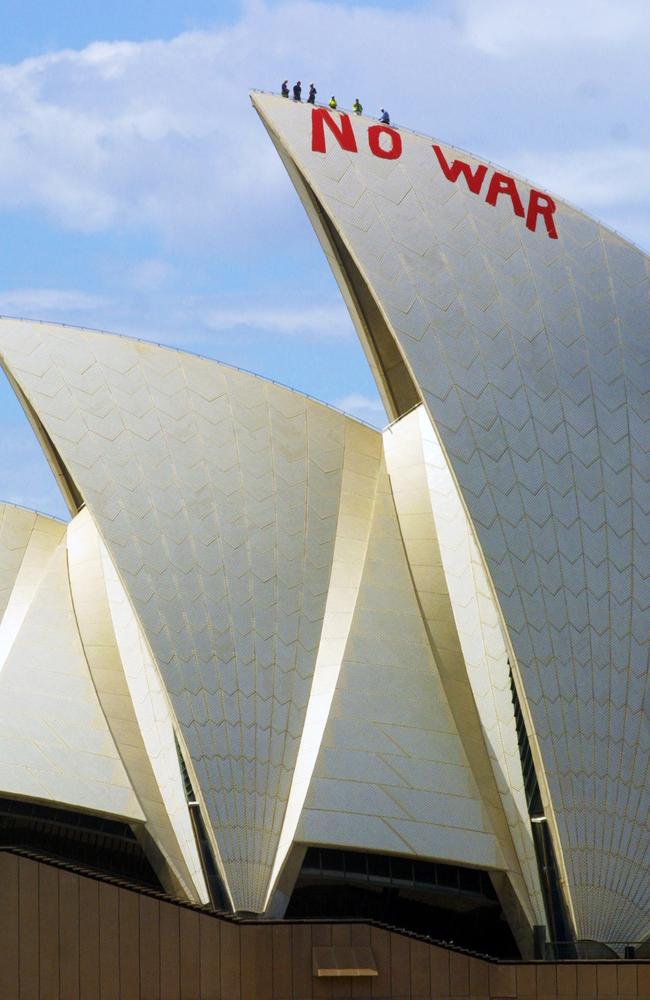 27. Protesters painted “NO WAR” on the sails of the Opera House shortly before the announcement that Australian troops would join any US-led military strike to disarm Iraq* in March 2003. Picture: Dan Peled/AP