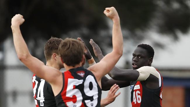 Tom Jok (right) celebrates with teammates after kicking the winning goal. Picture: Getty