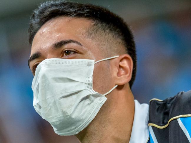 Brazil's Gremio supporter wears a protective face mask to prevent the spread of Coronavirus, before the Copa Libertadores match against Brazil's Internacional at the Arena do Gremio, in Porto Alegre, Brazil, on March 12, 2020. (Photo by SILVIO AVILA / AFP)