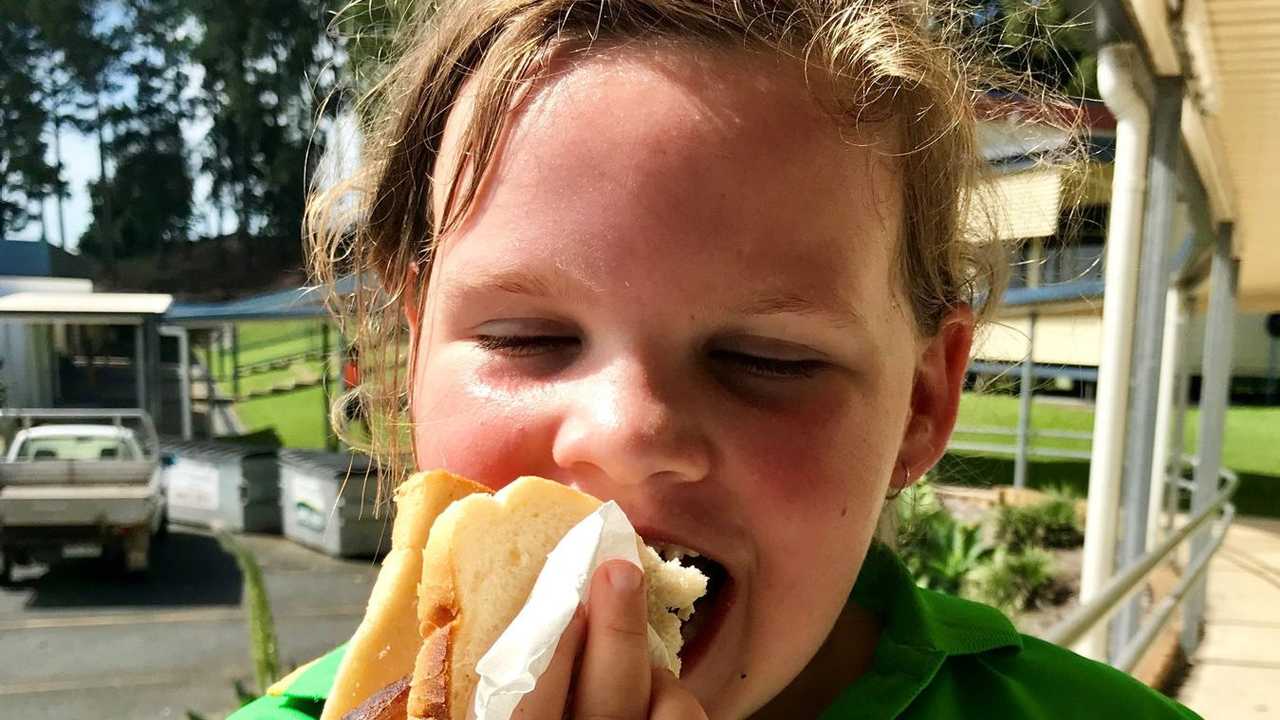 Helena Nissan, 7 (almost 8) tucks into an election snag. Picture: Angela Seng