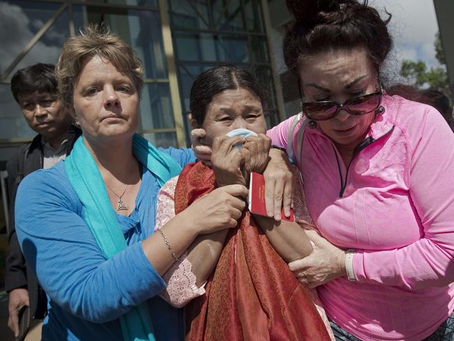 Phyu Hew Nu (C), the mother of Myanmar defendant Zaw Lin (not pictured), cries as she leaves the Koh Samui Provincial Court after her son was sentenced to death. Pictured: AFP / Nicolas Asfouri