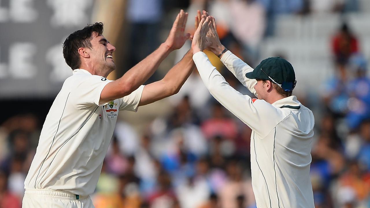 Pat Cummins and Steve Smith early in their Test match careers. Picture: AFP Photo