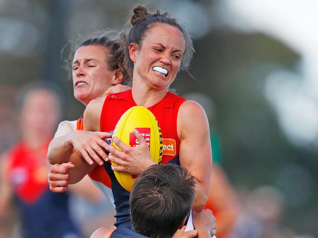 MELBOURNE, AUSTRALIA - FEBRUARY 03:  Daisy Pearce of the Demons is tackled during the round one AFLW match between the Melbourne Demons and the Greater Western Sydney Giants at Casey Fields on February 3, 2018 in Melbourne, Australia.  (Photo by Scott Barbour/Getty Images)