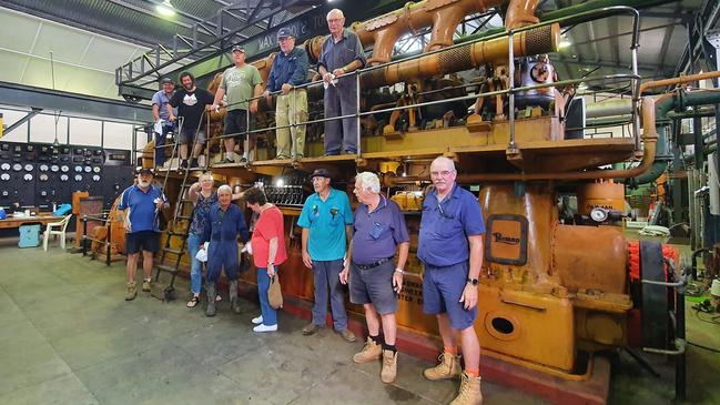 The engine in the power station, with members of Northern Rivers Powerhouse Museum Inc. Picture: Ian Mackie