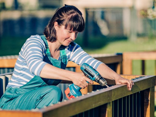 CAREERS: One side hustle is no longer enough to make ends meet, with a growing number of Australians requiring several income streams to pay their mortgage and put food on the table.  Generic woman building fence. Picture: iStock