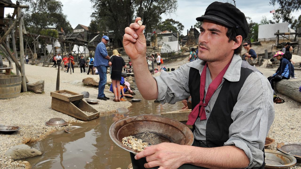 Panning for gold at the Gold Rush museum Sovereign Hill at Ballarat, Victoria. You can see a cradle in the background.