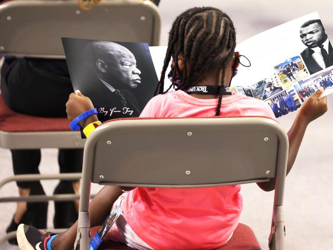 A young girl reads a program during a service celebrating the life of John Lewis in his hometown of Troy, Alabama. Picture: Getty Images/AFP