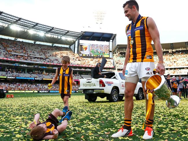 Luke Hodge celebrates last year’s premiership with two of his three sons, Cooper and Chase. Picture: Colleen Petch