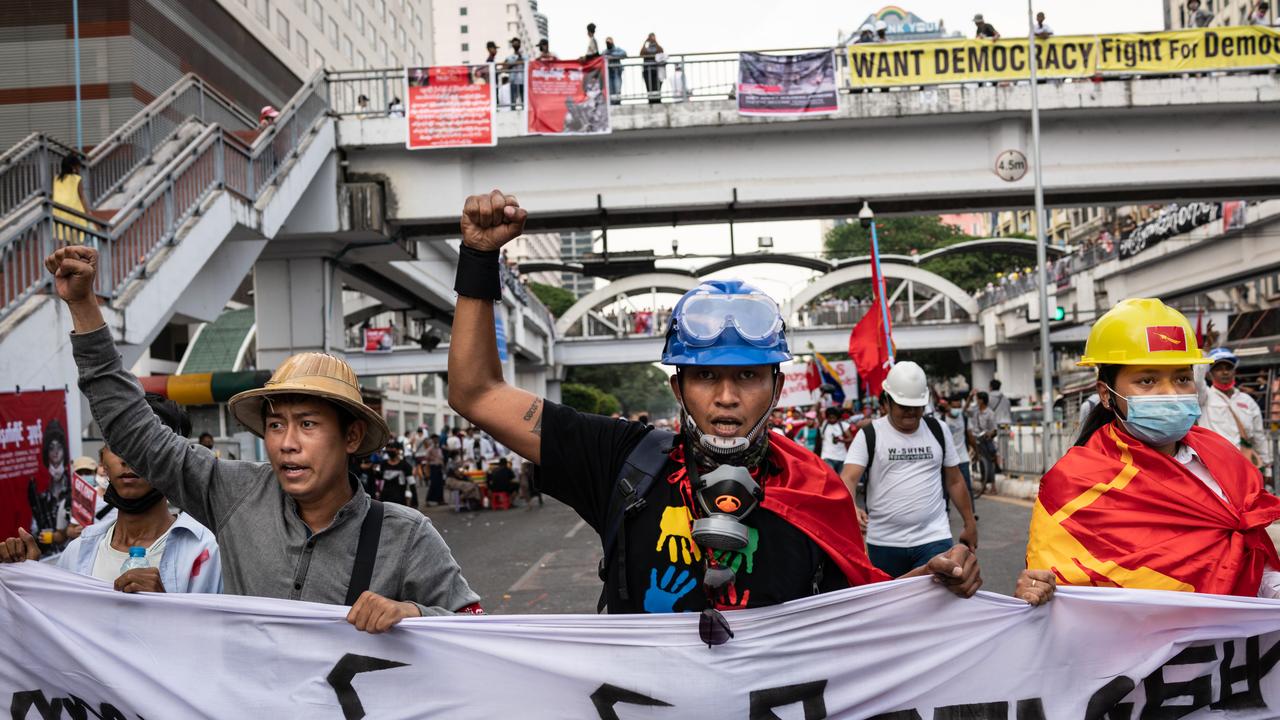 Protesters shout slogans while marching with a banner in Yangon, Myanmar. Picture: Hkun Lat/Getty Images