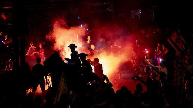 Mounted police officers clash with protesters as they are setting fires and use smoke torches during a demonstration calling for a hostages deal.