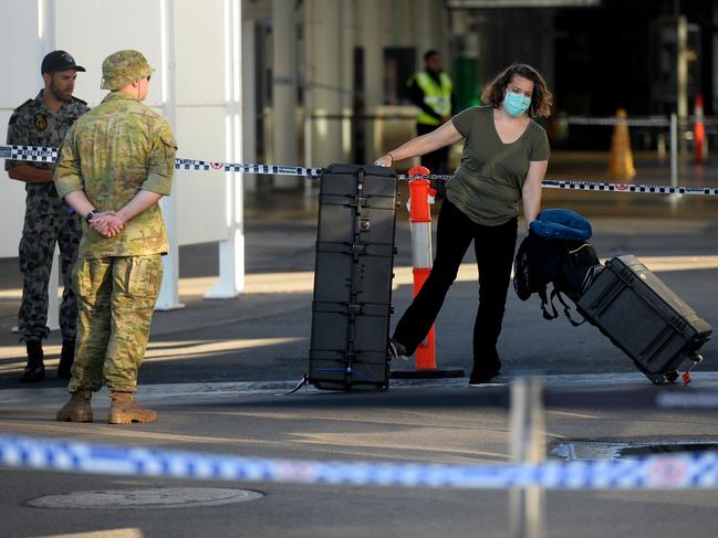 New arrivals at Sydney International airport are ushered into waiting buses for hotel quarantine.  Photo Jeremy Piper