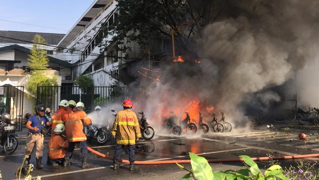 Firefighters try to extinguish a blaze following a blast at the Pentecost Church Central Surabaya (GPPS). Picture: Reuters.