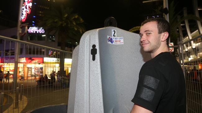 Dylan McCartney uses the open-air-urinal on Cavill Ave.